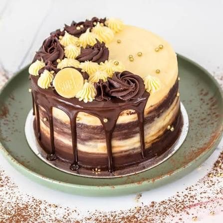 Chocolate drip cake with gold buttercream swirls